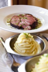 Mashed potatoes with gammon, smoked pork, and broad beans