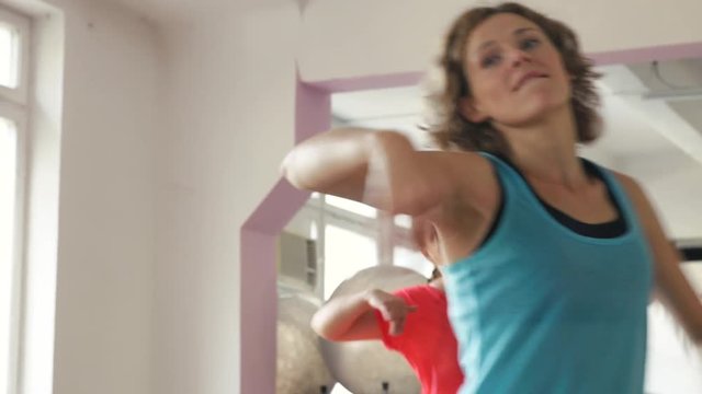 Female team dancing zumba fitness in the gym. Active lifestyle and body improvement.