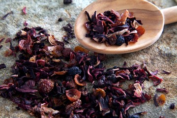 Fruit tea with a wooden spoon on a stone slab