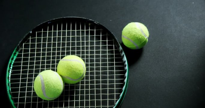 Tennis balls and racket in studio 