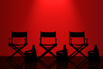 Fototapeta premium Director Chairs, Movie Clappers and Megaphones with Red Backlight in front of Wall. 3d Rendering