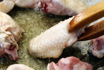 Chicken meat frying in paella pan