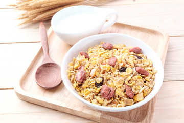 cornflakes and dry fruits on wooden background