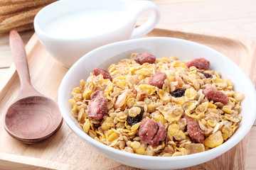 cornflakes and dry fruits on wooden background