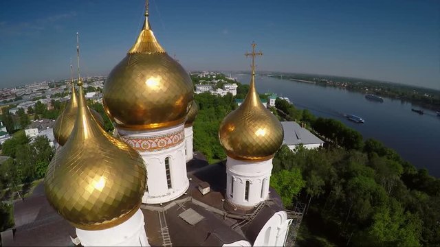 Fast flight aroud golden domes Valday Iversky Russian Orthodox Monastery. Valdaysky National Park UNESCO Biosphere Reserve Lake Seliger. Aerial drone. Beautiful nature summer clouds horizon.