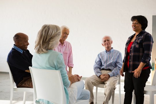 Woman talking to friends sitting on chair