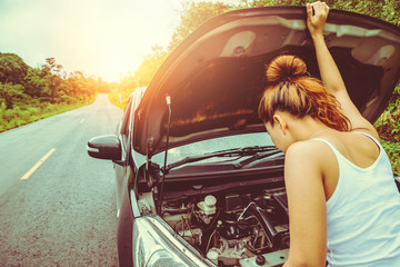 Asian women travel relax in the holiday. Broken car on the street. Thailand