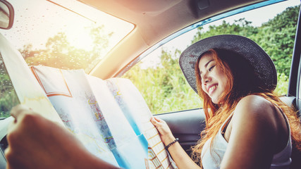 Asian women travel relax in the holiday. Driving a travel map happy travel