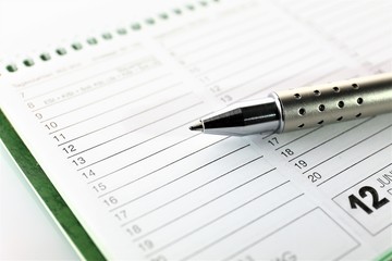 An Image of a calendar and a pen - business