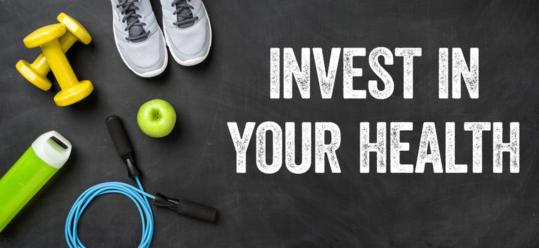 Fitness equipment on a dark background - Invest in your health