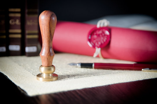 Law, attorney, notary public stamp and pen on desk