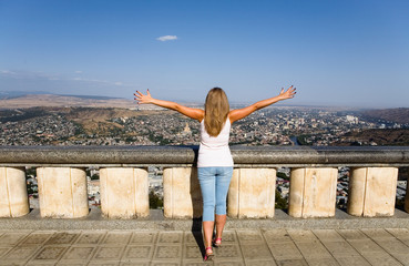 Fototapeta na wymiar Girl at the observation deck on the background of Tbilisi.