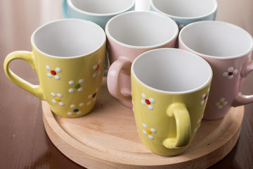 Empty cups on the wooden board with backlight