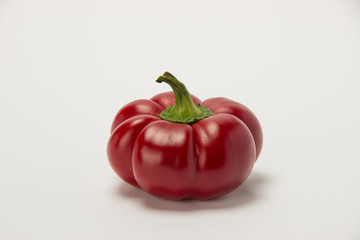 Dark red large pepper on a white background