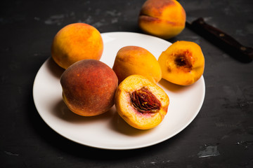 Fresh ripe peaches on the rustic background. Selective focus.