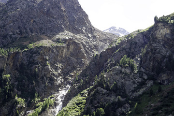 a river flows between the mountains