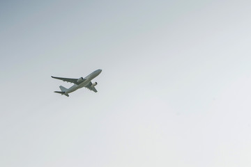 Fototapeta na wymiar White airplane profile plane climb up the height of cloud sun glare blank no label