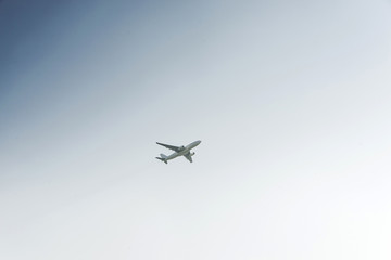 White airplane profile plane climb up the height of cloud sun glare blank no label