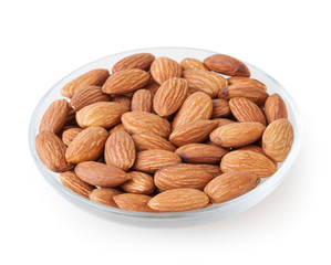 Almonds in glass plate isolated on white background