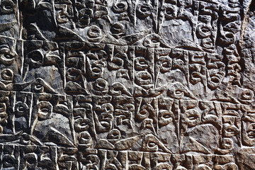 Buddhist religious symbols inscriptions in Tibet old runes