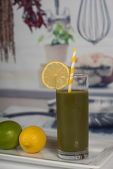 Green shake smoothie drink in a kitchen setting
