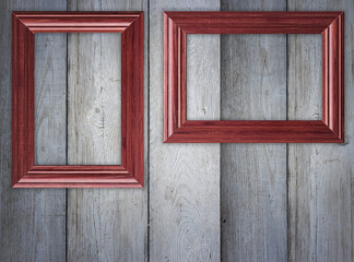 Blank frames on wooden wall
