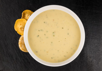 Rustic slate slab with Chanterelle Soup, selective focus