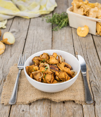Fresh made Fried Chanterelles on a rustic background