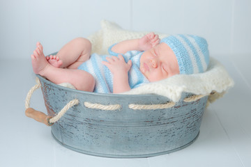 Sweet newborn infant sleeping in little bath