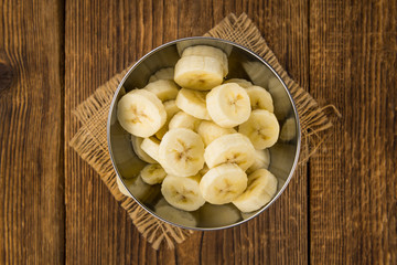 Wooden table with Sliced Bananas, selective focus