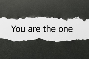 You are the one word written under torn paper.