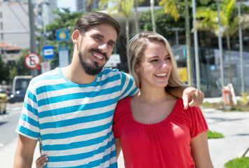Obraz premium Caucasian girl with hispanic boyfriend in the city