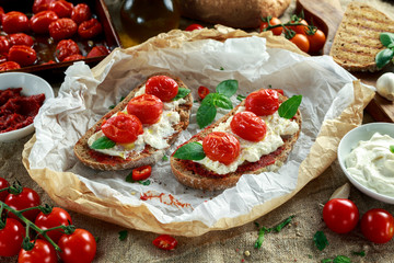 Tomato Ricotta Bruschetta with sun dried tomatoes paste, olive oil brown bread and basil