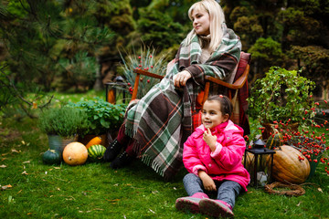 Mother and daughter playing in beautiful autumn park