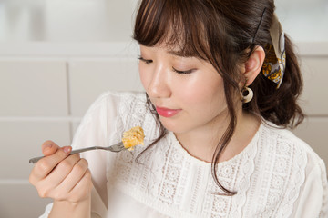 Young Japanese woman eating cake - 174844650