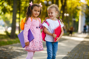Adorable little schoolgirl feeling extremely excited about going back to school