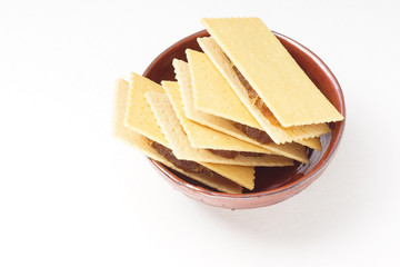 cheese biscuit stuff with pineapple jam in ceramic bowl on rough paper