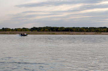 Obraz premium Fishermen ride on a motor boat on the river, Russia, Astrakhan