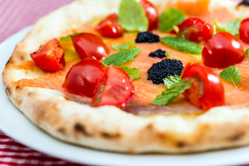 tasty salmon pizza on a the table