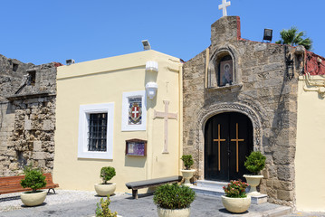 Small Greek church mounted in wall of old fortress in Rhodes town on Rhodes island