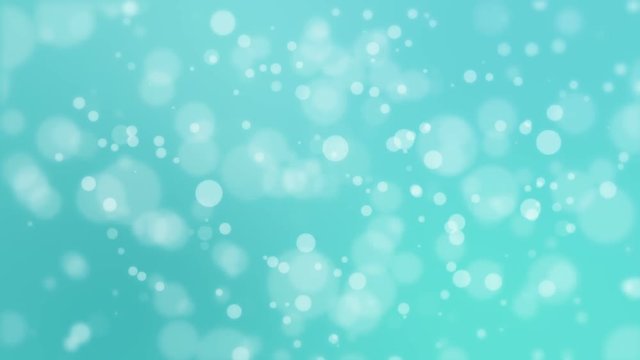 Festive turquoise blue glowing bokeh background with floating light particles.