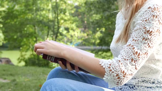 4k.  Body of girl outdoor with Bible. Study Christianity