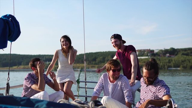 Group of friends having a good time together when traveling by yacht