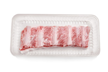 Container with fresh raw ribs on white background