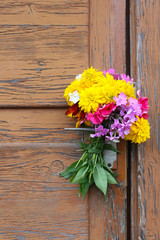 Bouquet of summer wildflowers. Phloxes and rudbeckia on old wooden door background.