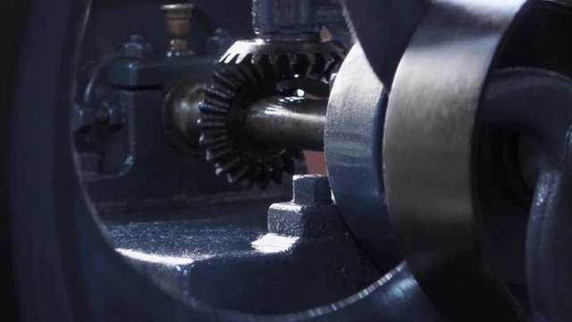 Industrial steam powered cogs turning on a machine