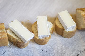 Tasty slices of cheese on French baguette.