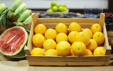 Wooden crate with fresh citrus fruit at market