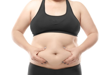 Woman touching fat on her belly against white background. Weight loss concept