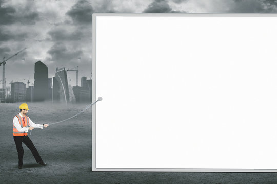 Italian engineer pulling a blank board